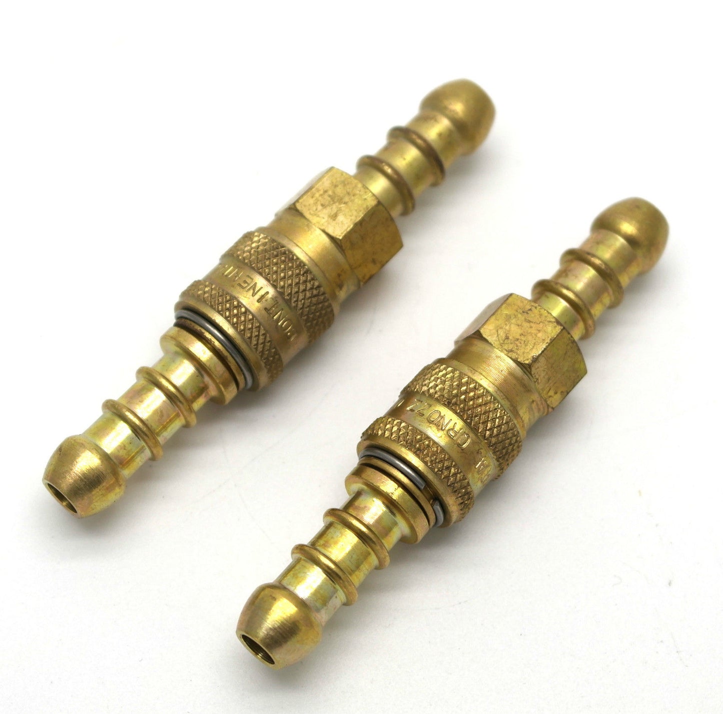 Two brass 8mm quick release connectors on a white background